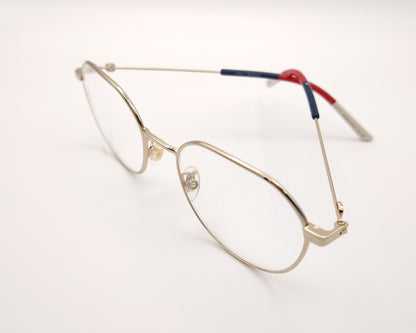 gafas gucci metálicas doradas con forma redonda y varillas en rojo azul y beige