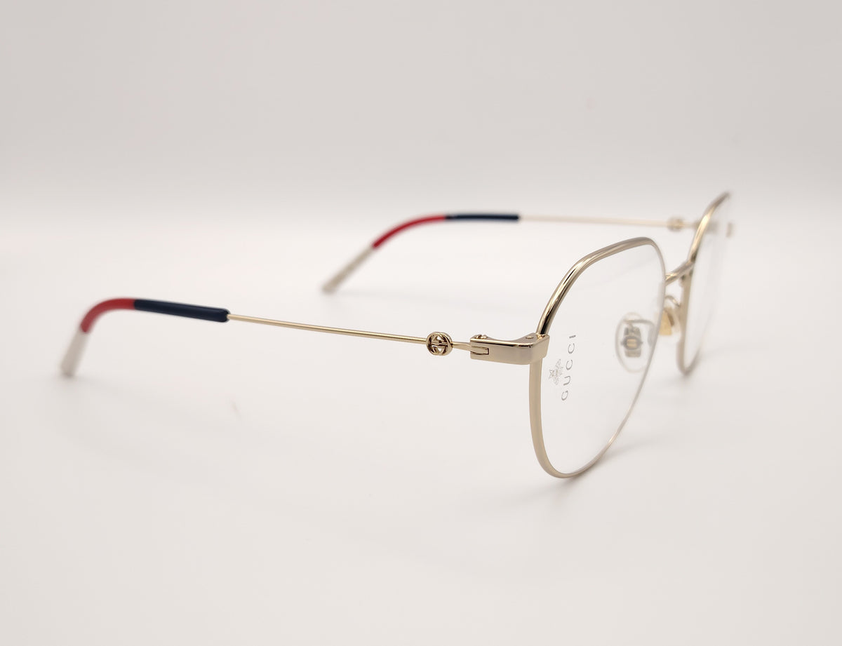gafas gucci metálicas doradas con forma redonda y varillas en rojo azul y beige