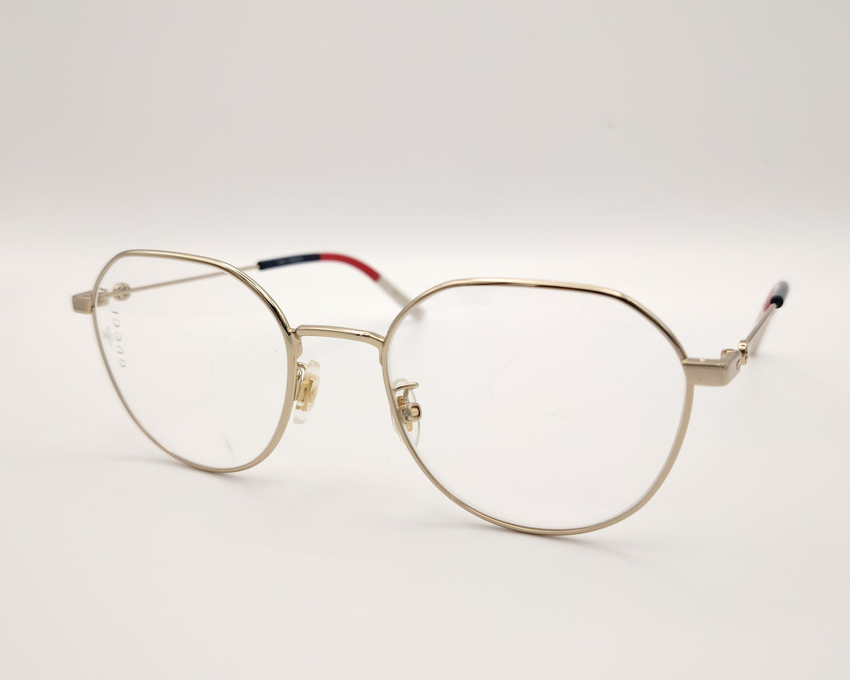 gafas gucci metálicas doradas con forma redonda y varillas en rojo azul y beige