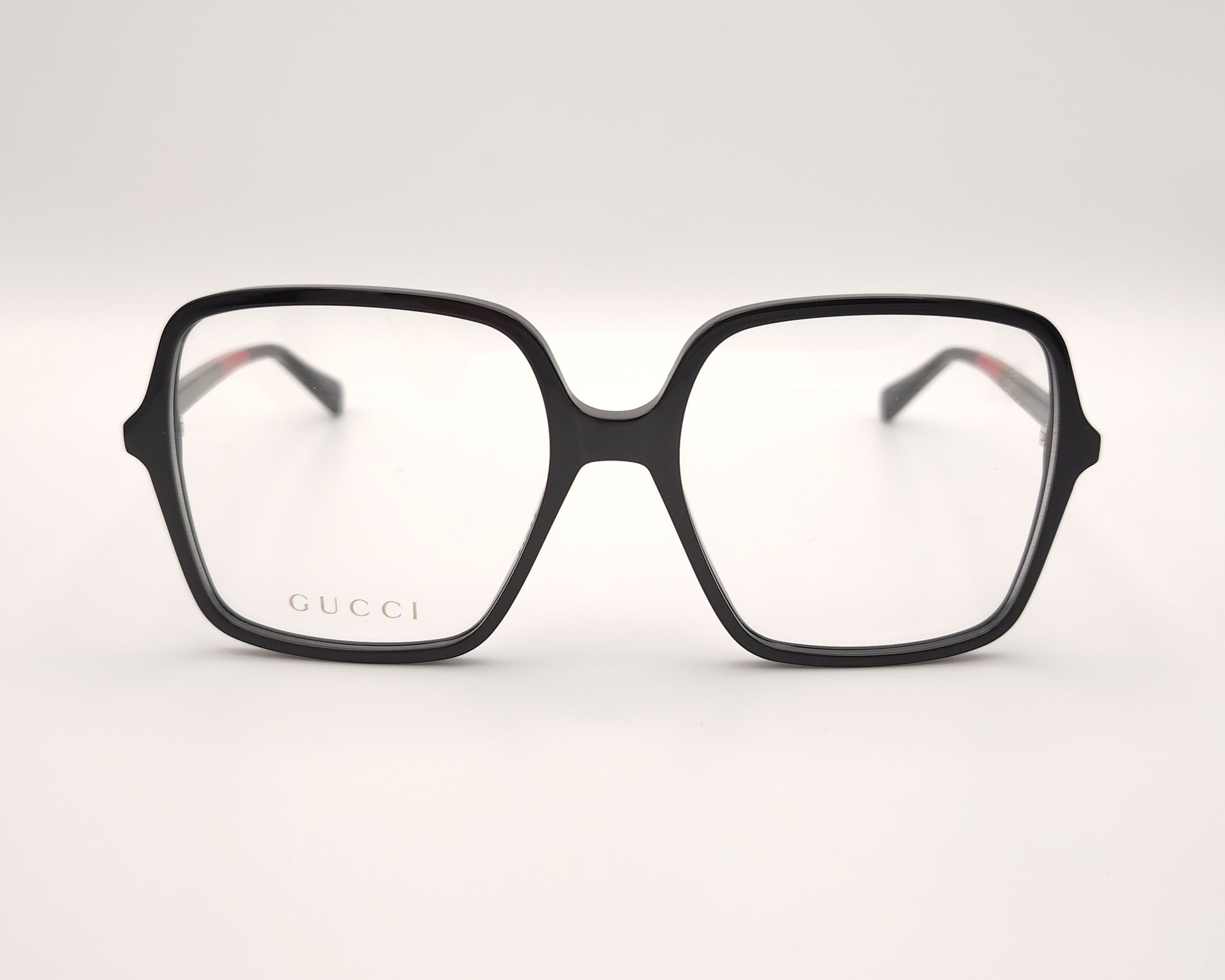 gafas gucci negras cuadradas oversize con varillas verdes rojas y negras