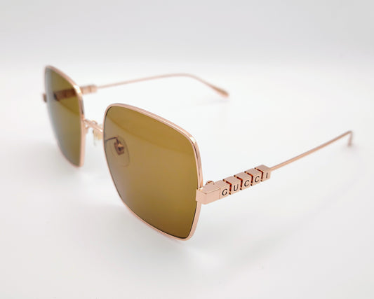 gucci gg1434s 002 gafas de sol metálicas doradas con lentes marrones y logo en las varillas