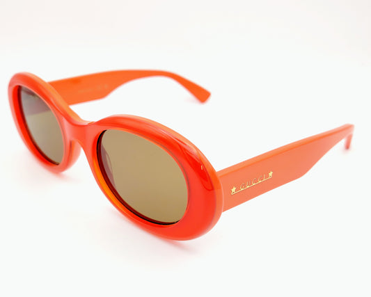 gucci gg1587s 003 gafas de sol de acetato en forma ovalada en color naranja intenso con las lentes en marrón, varillas con logo en color dorado