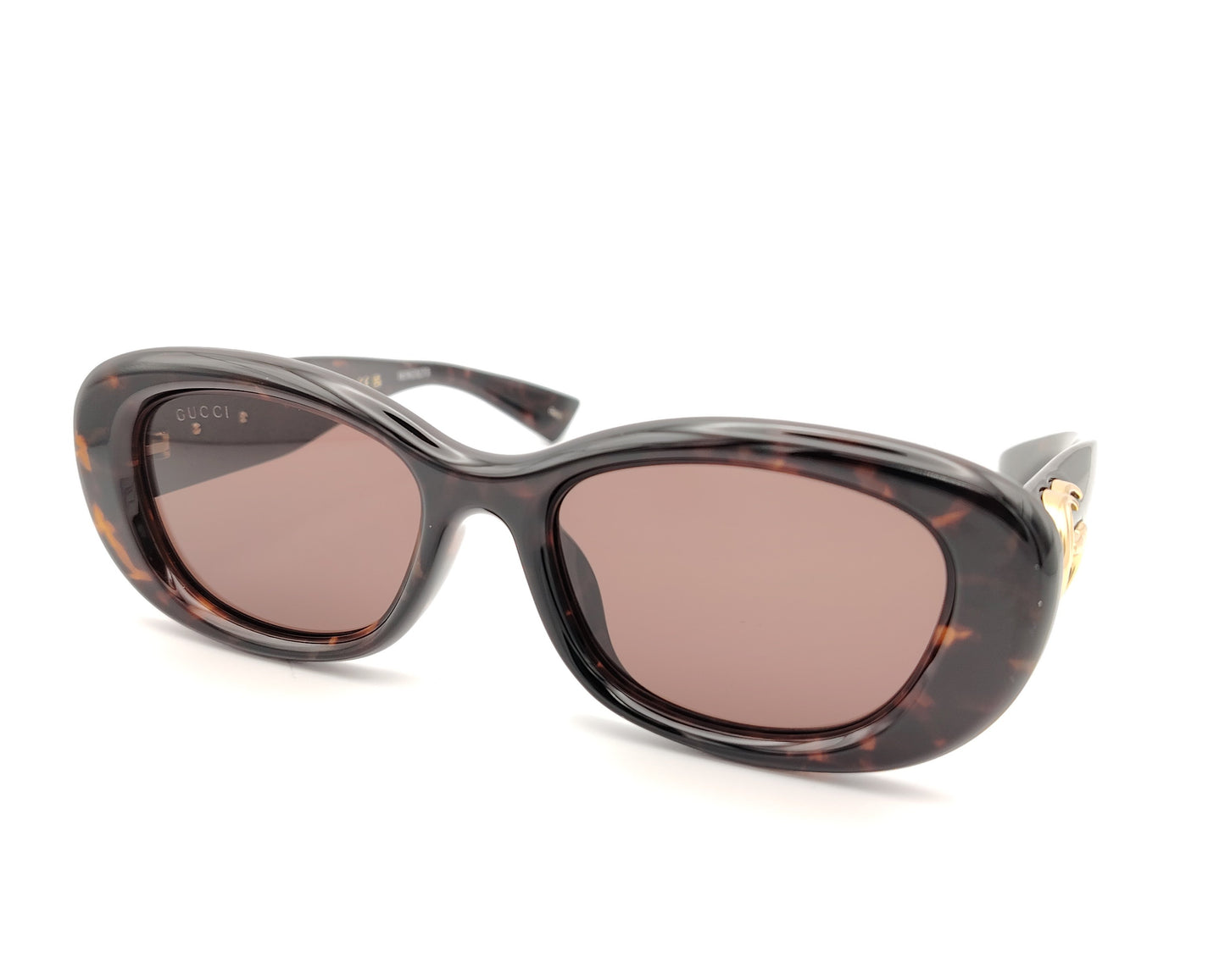 gafas de sol gucci ovaladas con montura carey y logo dorado en la varilla