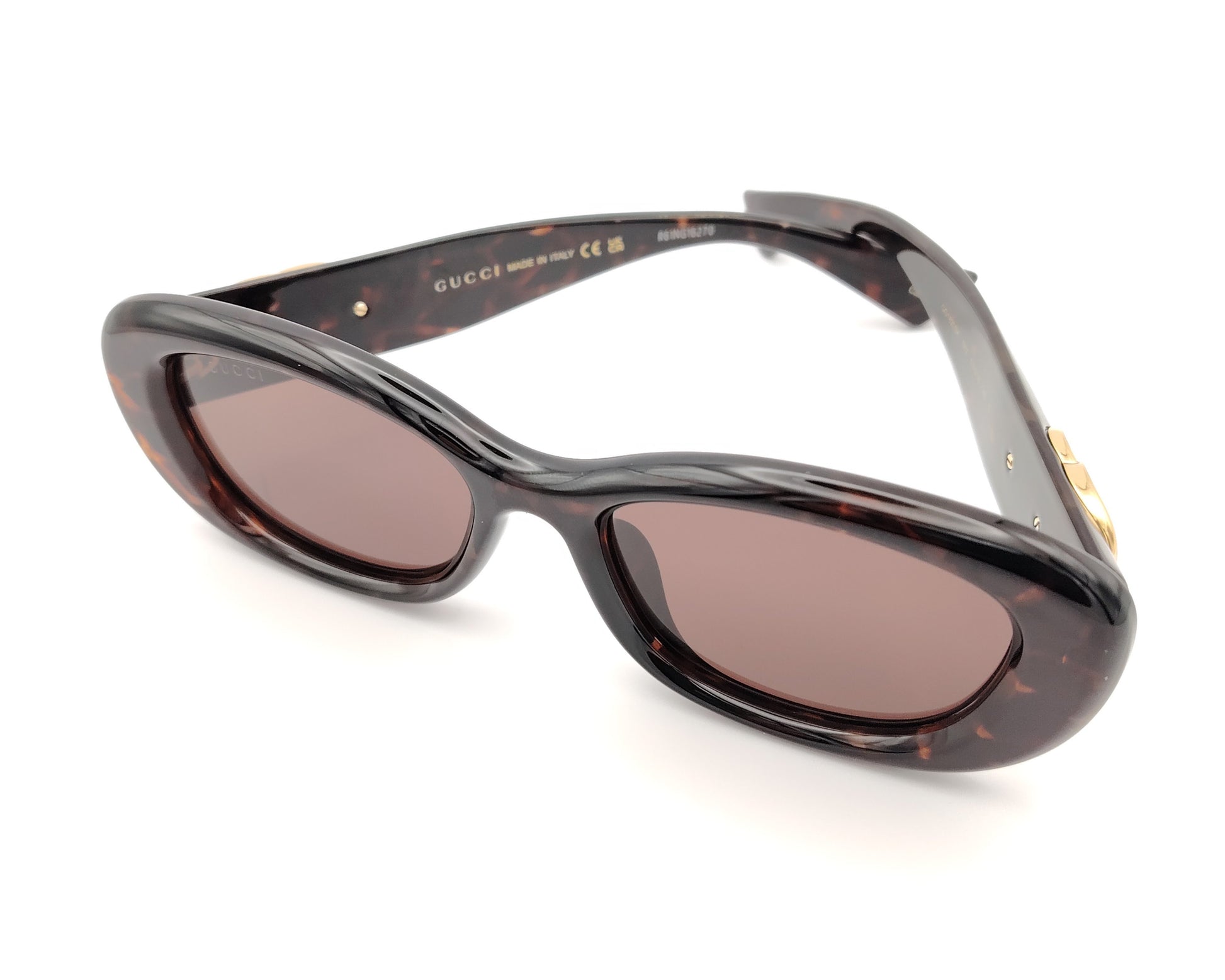 gafas de sol gucci ovaladas con montura carey y logo dorado en la varilla