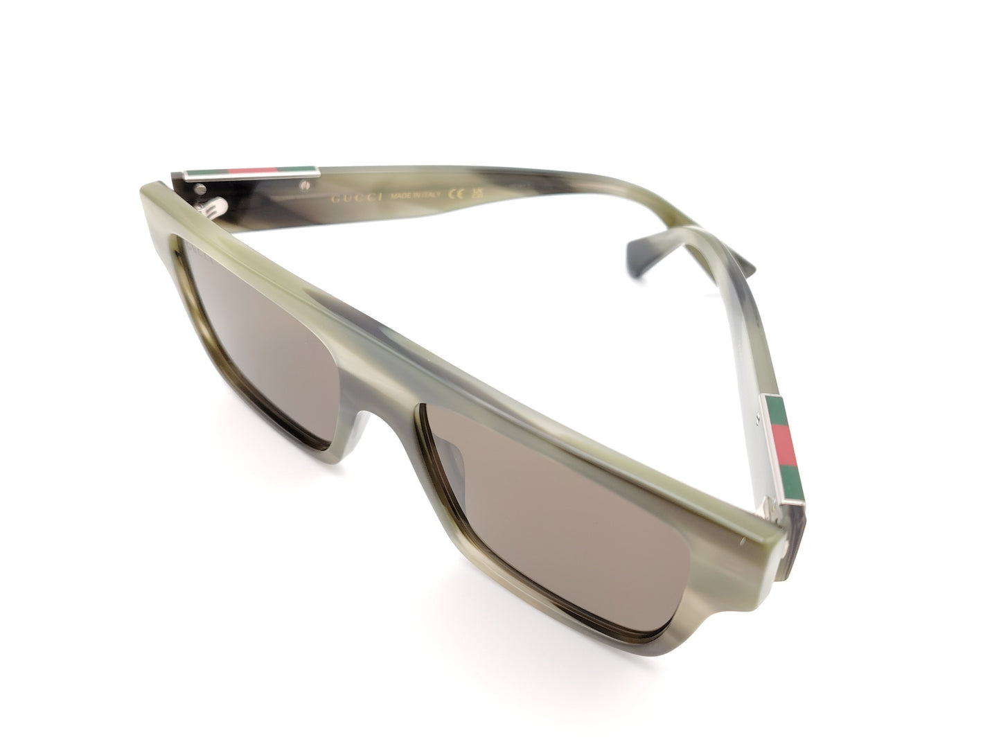 gafas de sol gucci con montura cuadrada verde translúcida y lentes marrones
