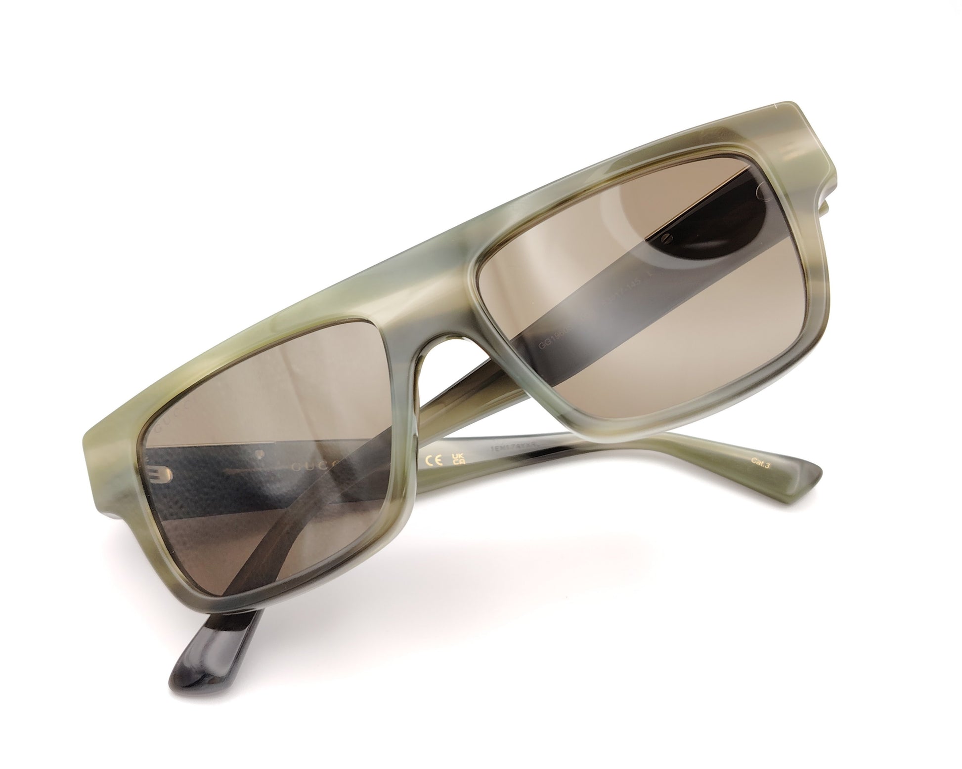 gafas de sol gucci con montura cuadrada verde translúcida y lentes marrones