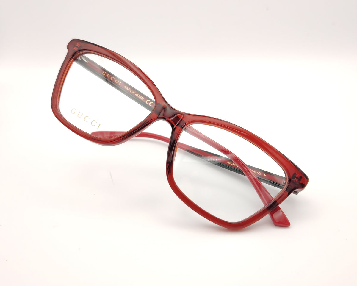 gafas gucci graduadas con montura roja translúcida varillas en rojo y verde  y detalle gg metálico 