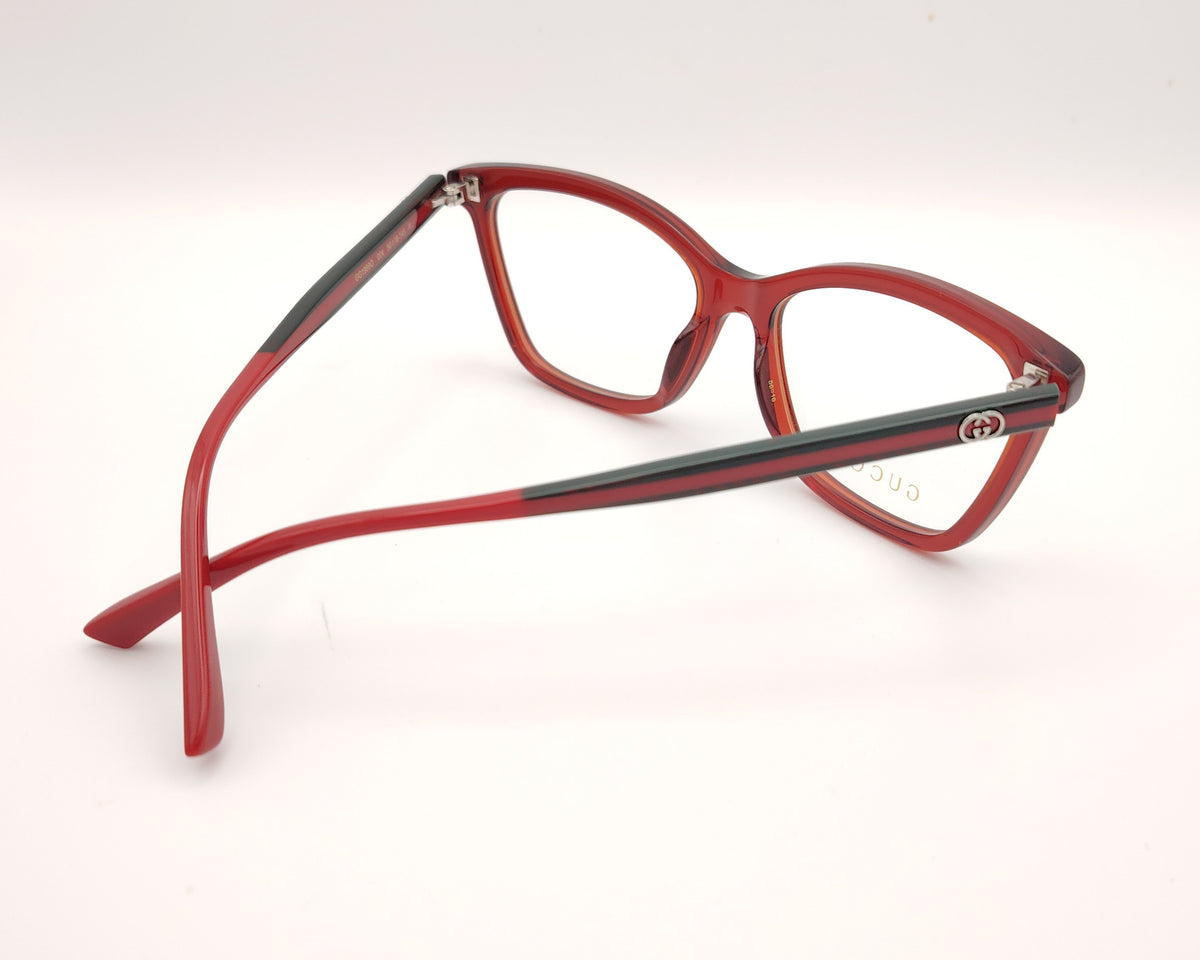 gafas gucci graduadas con montura roja translúcida varillas en rojo y verde  y detalle gg metálico 