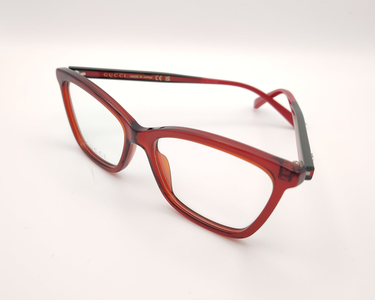 gafas gucci graduadas con montura roja translúcida varillas en rojo y verde  y detalle gg metálico 
