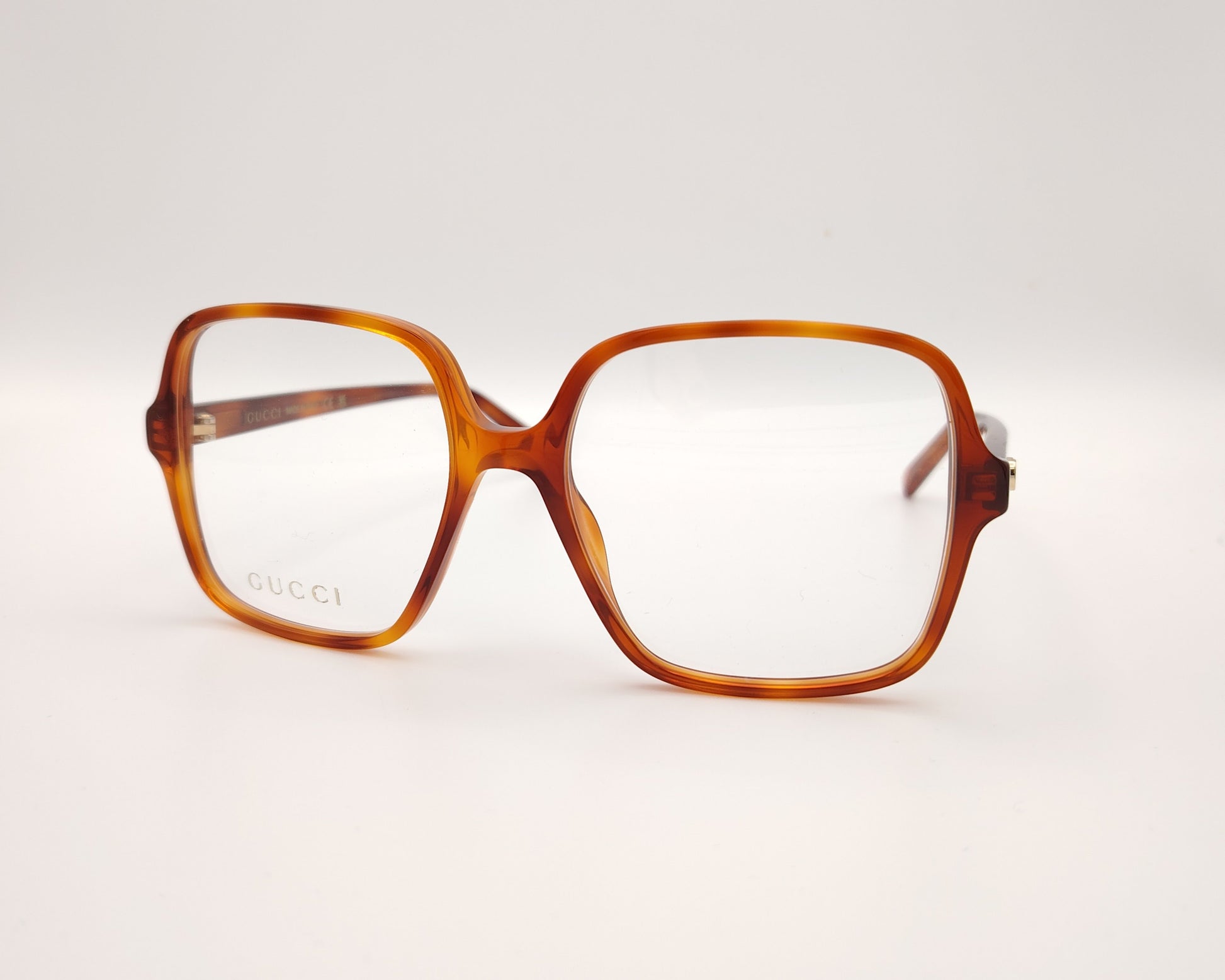 gafas gucci cuadradas de acetato caramelo con logo dorado en las varillas