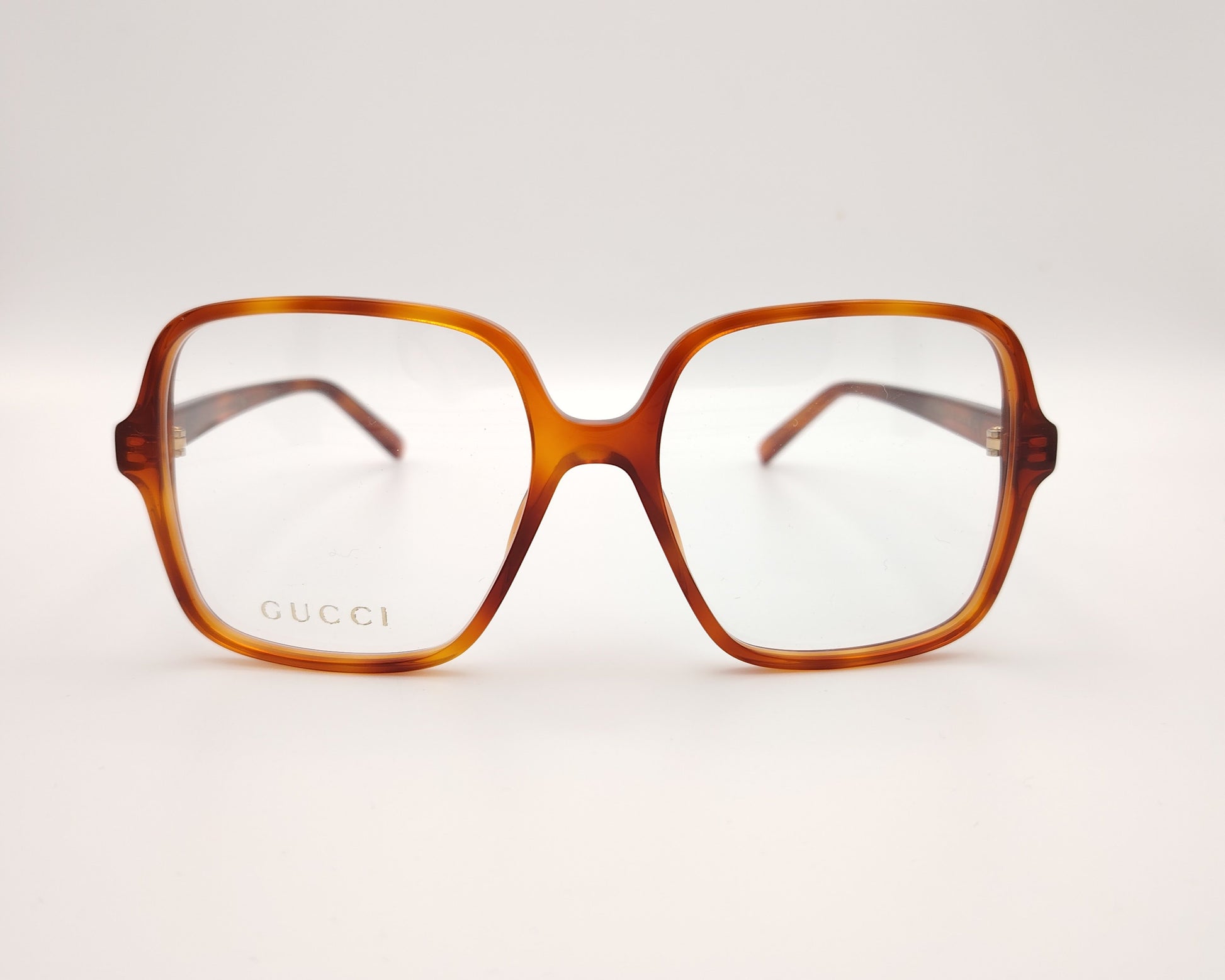 gafas gucci cuadradas de acetato caramelo con logo dorado en las varillas