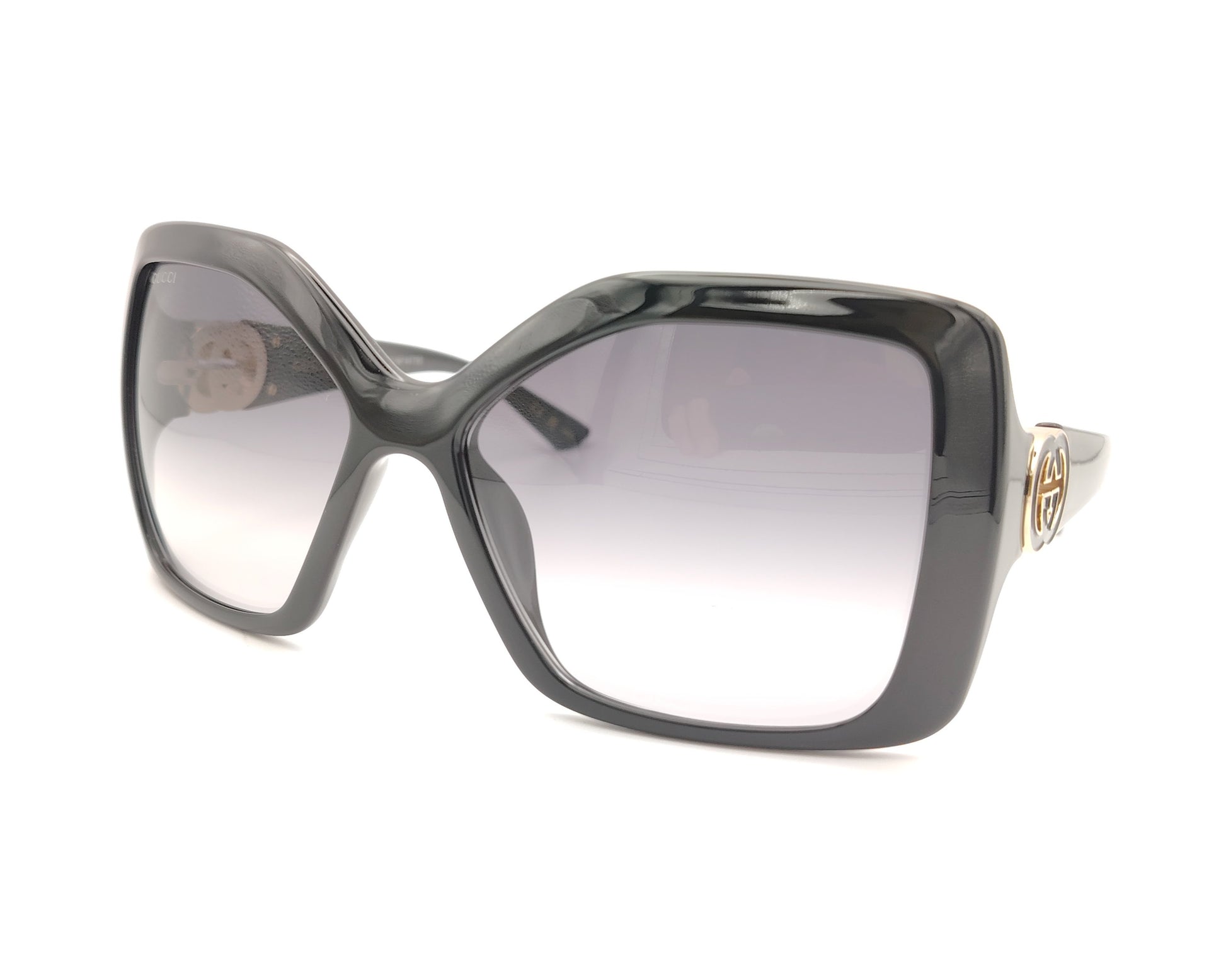 gafas de sol gucci cuadradas oversize negras con lentes grises degradadas y logo dorado en las patillas