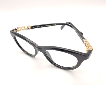 gafas gucci negras redondeadas con logo dorado en varilla