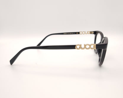 gafas gucci negras redondeadas con logo dorado en varilla