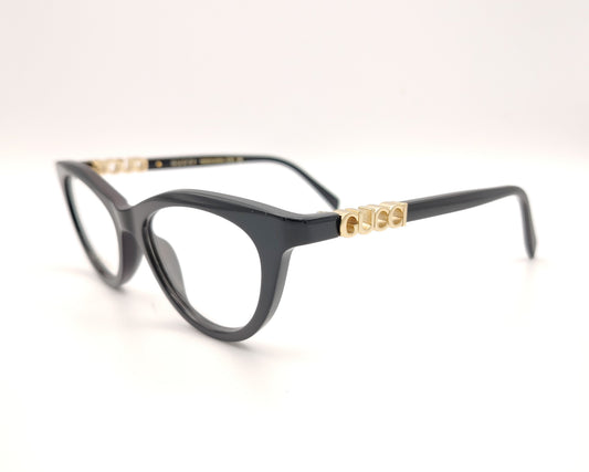 gafas gucci negras redondeadas con logo dorado en varilla