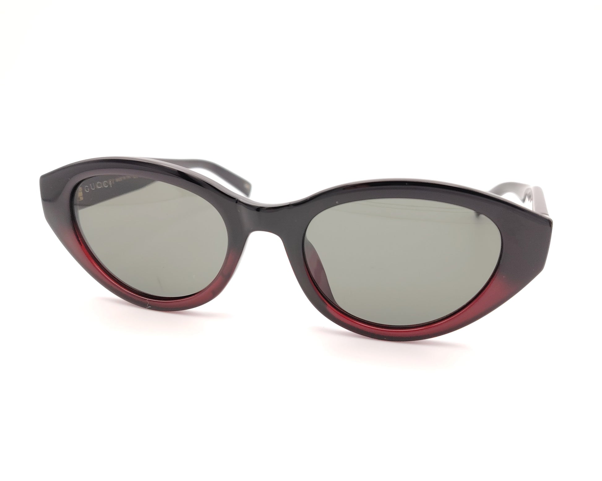 gafas de sol gucci ovaladas negras con detalle burdeos y varillas con logo dorado y bandas verde y roja