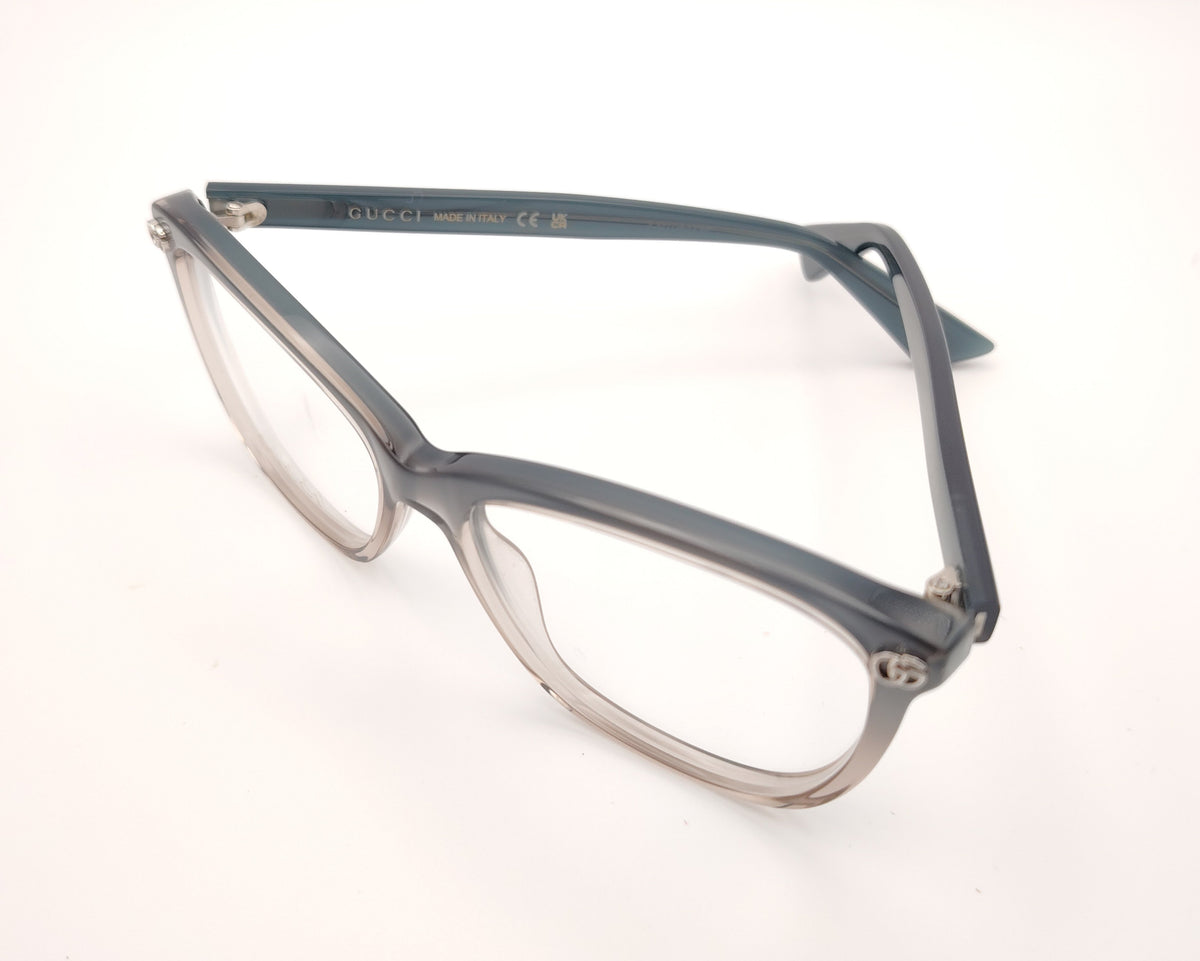gafas gucci graduadas con montura degradada gris humo y transparente y detalle gg metálico