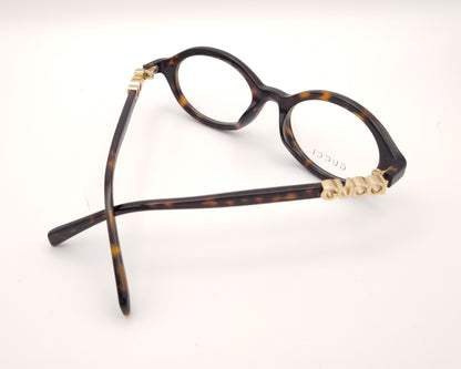 gafas gucci graduadas redondas de acetato carey con logo dorado en las varillas