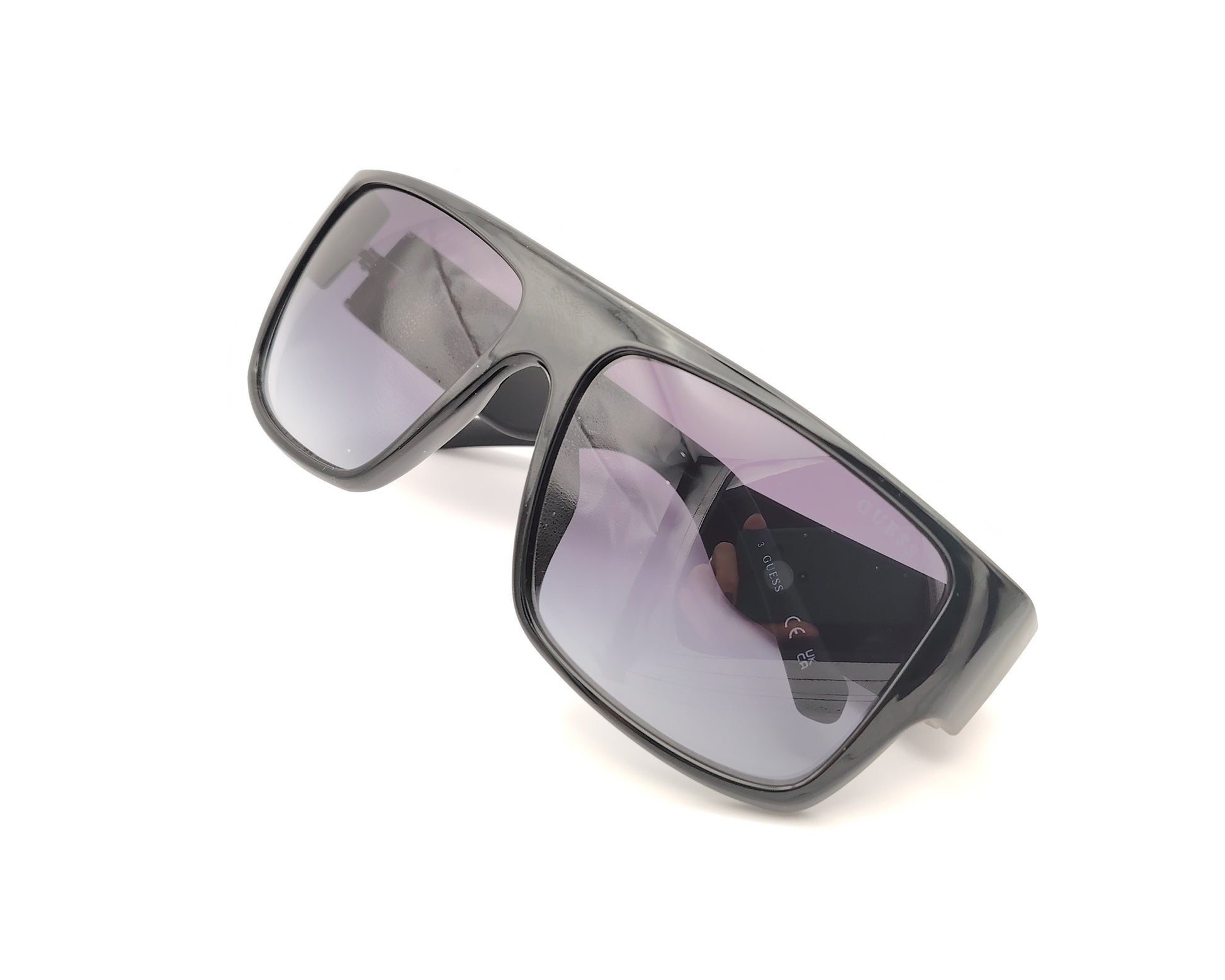 gafas de sol guess negras con diseño envolvente, lente degradada y logo en relieve