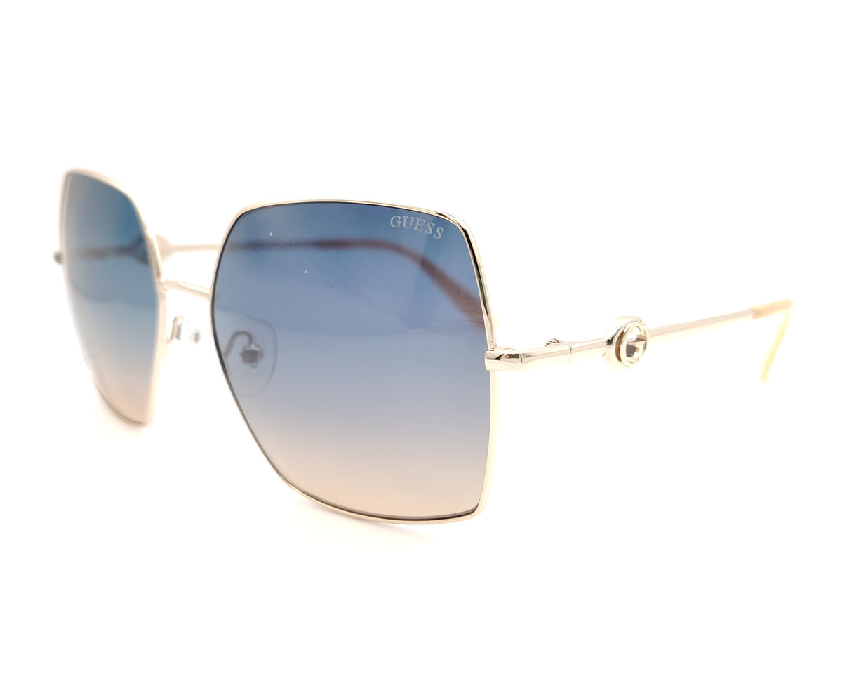 gafas guess cuadradas con montura dorada fina y lentes degradadas azul y marrón