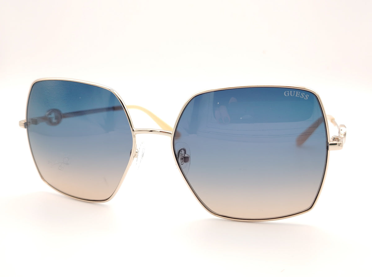 gafas guess cuadradas con montura dorada fina y lentes degradadas azul y marrón