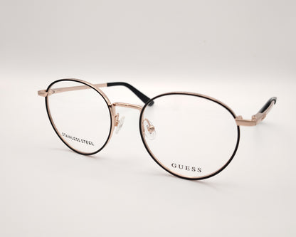 gafas de vista guess con montura redonda de metal dorado con el perfil de los aros en negro