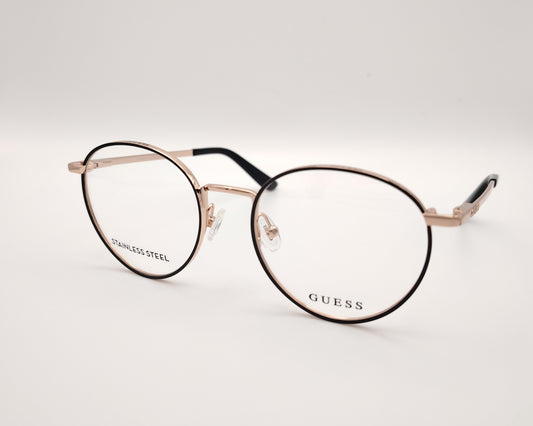 gafas de vista guess con montura redonda de metal dorado con el perfil de los aros en negro