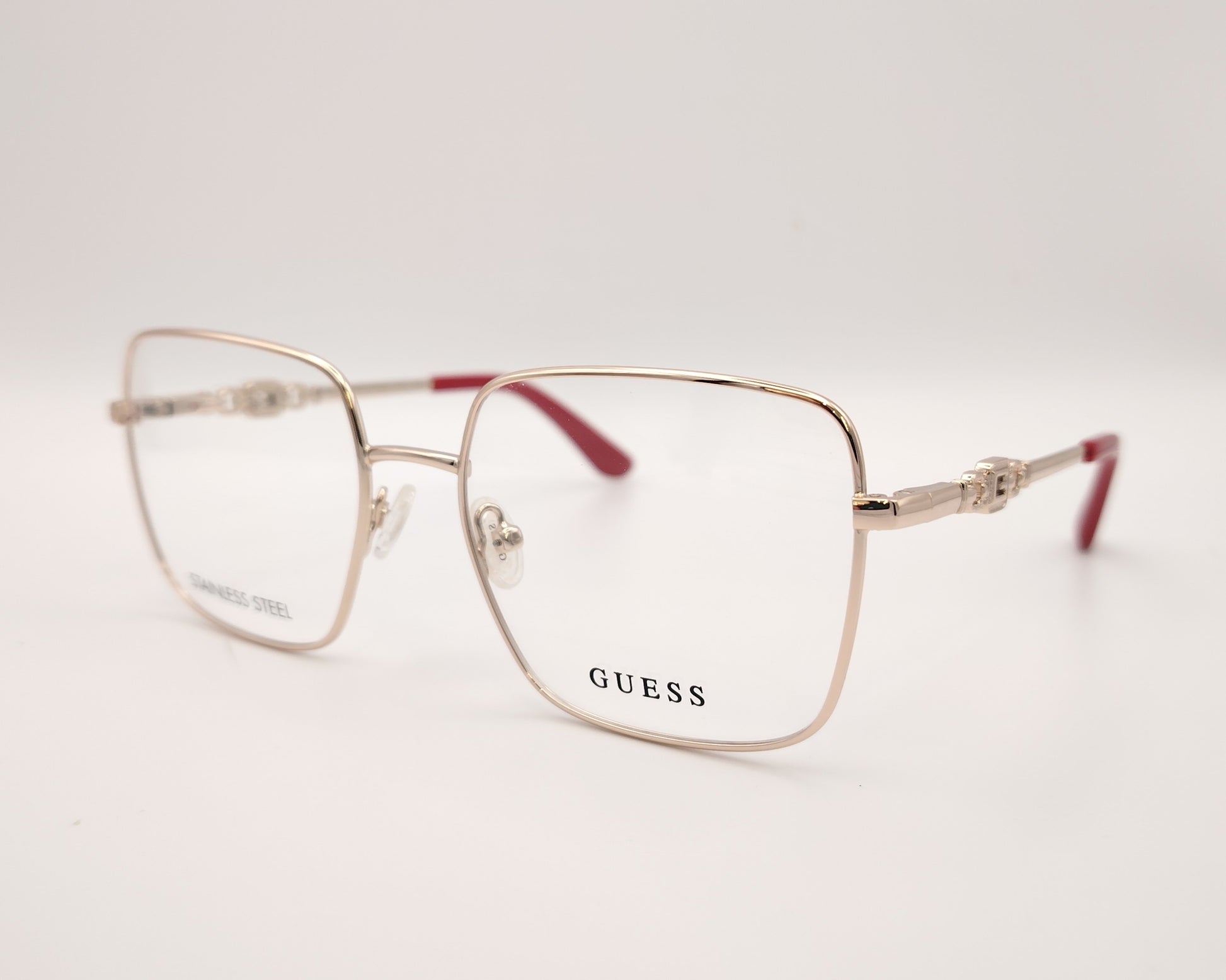 gafas graduadas guess de acero inoxidable doradas con forma cuadrada y terminales rojos