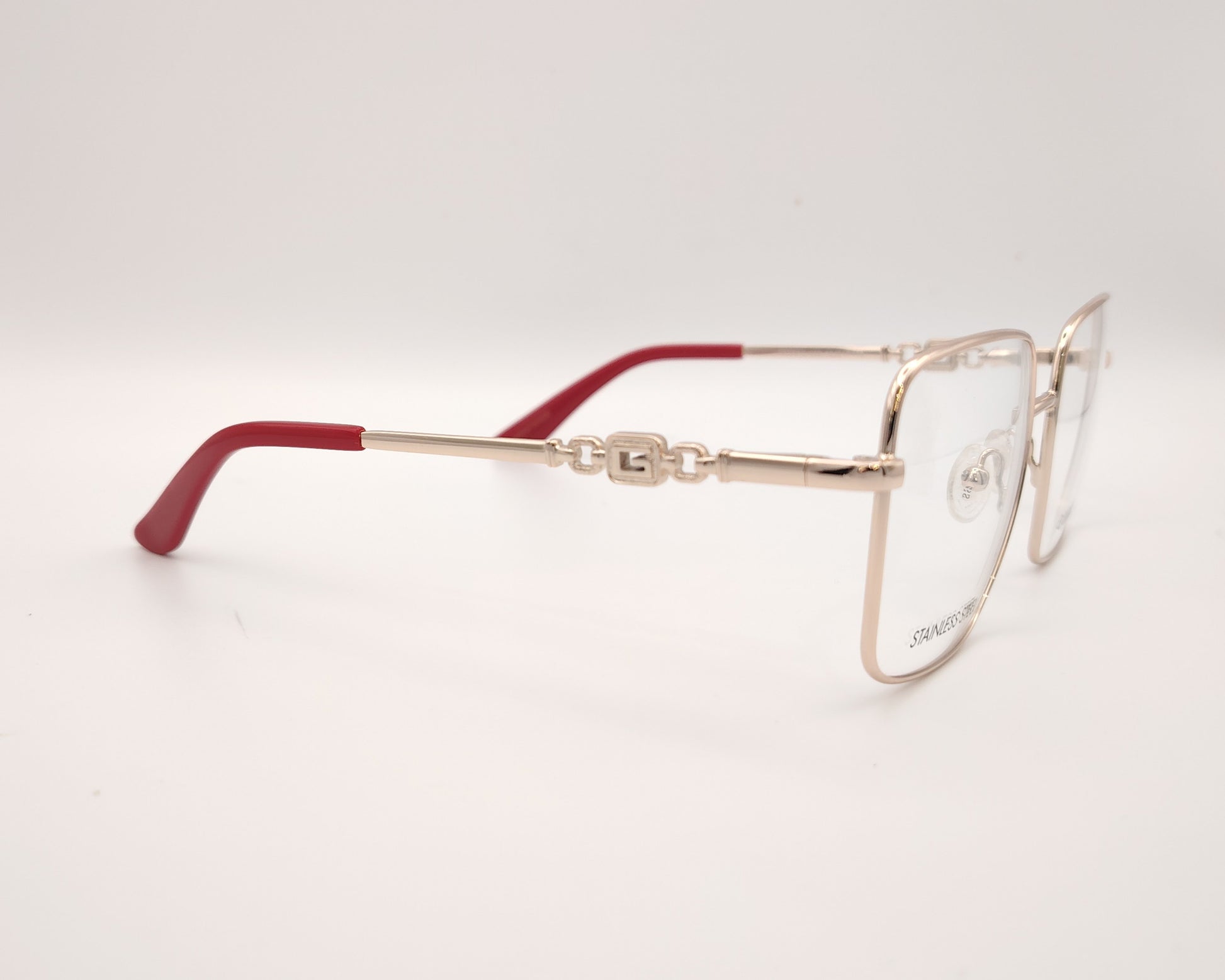 gafas graduadas guess de acero inoxidable doradas con forma cuadrada y terminales rojos