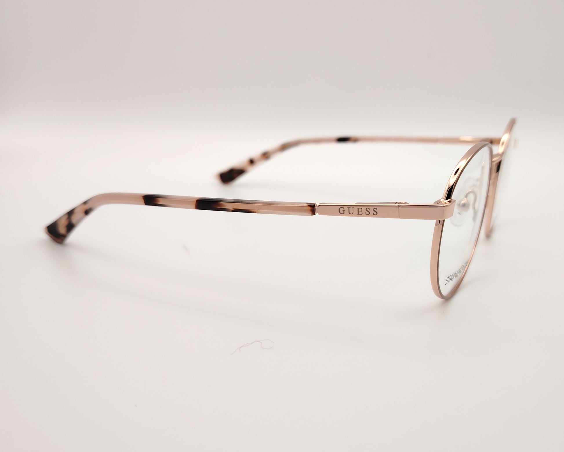 gafas de vista guess con montura redonda de metal en color oro rosa y terminales de carey