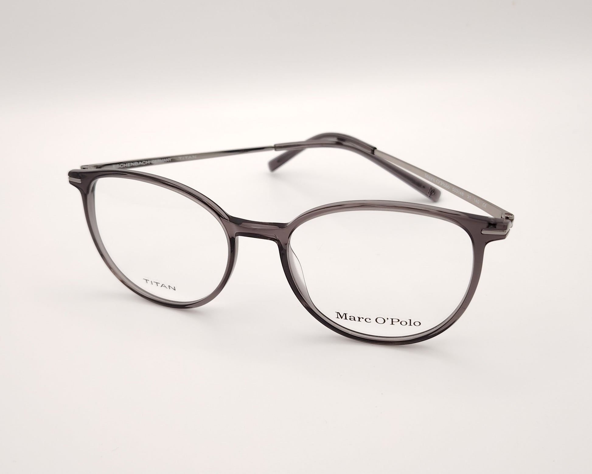 gafas marc o´polo de pasta redonda en color gris traslúcido con varillas de metal