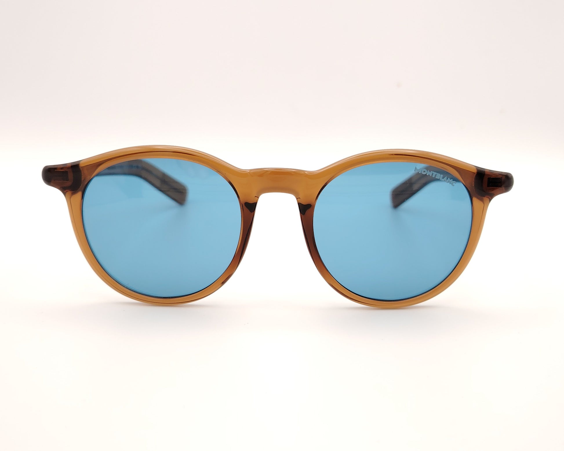 gafas de sol montblanc redondas con montura color ámbar y cristales azules