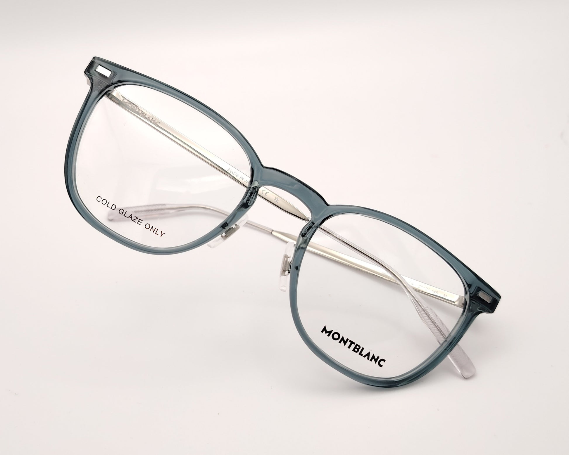 gafas montblanc con montura azul translúcida rectangular y varillas metálicas en plata