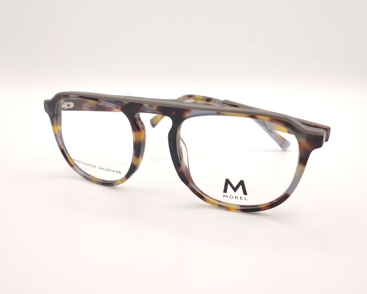 gafas de vista morel nomad con montura redondeada de acetato jaspeado en tonos marrón, gris y mostaza 