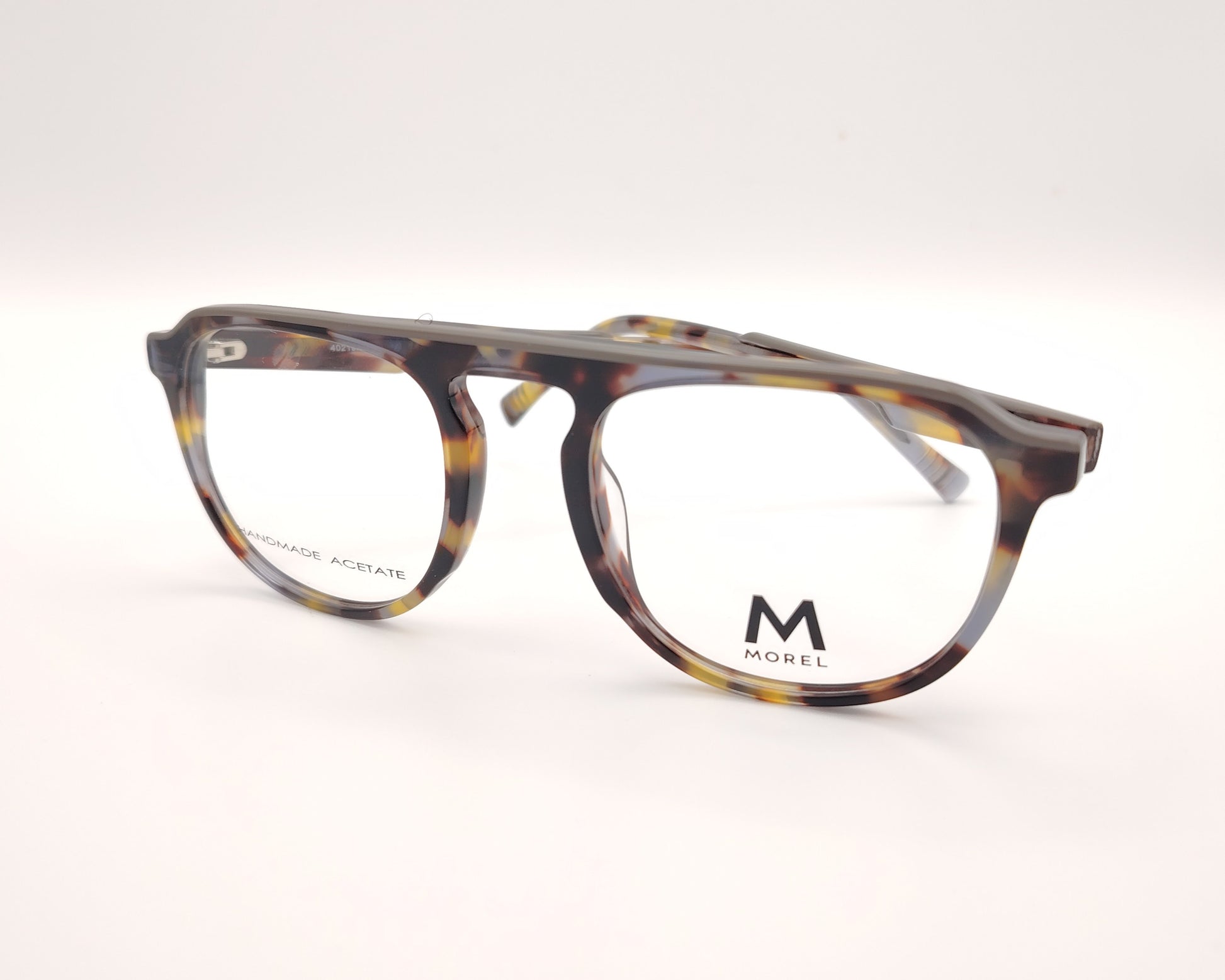 gafas de vista morel nomad con montura redondeada de acetato jaspeado en tonos marrón, gris y mostaza 