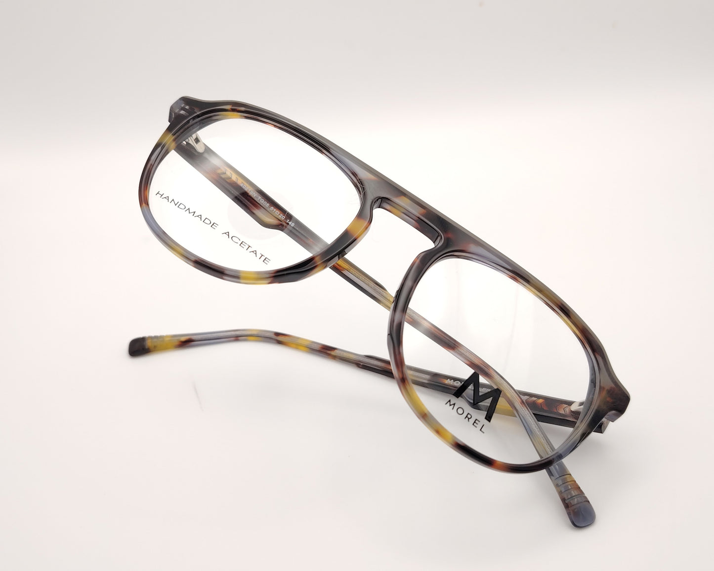 gafas de vista morel nomad con montura redondeada de acetato jaspeado en tonos marrón, gris y mostaza 