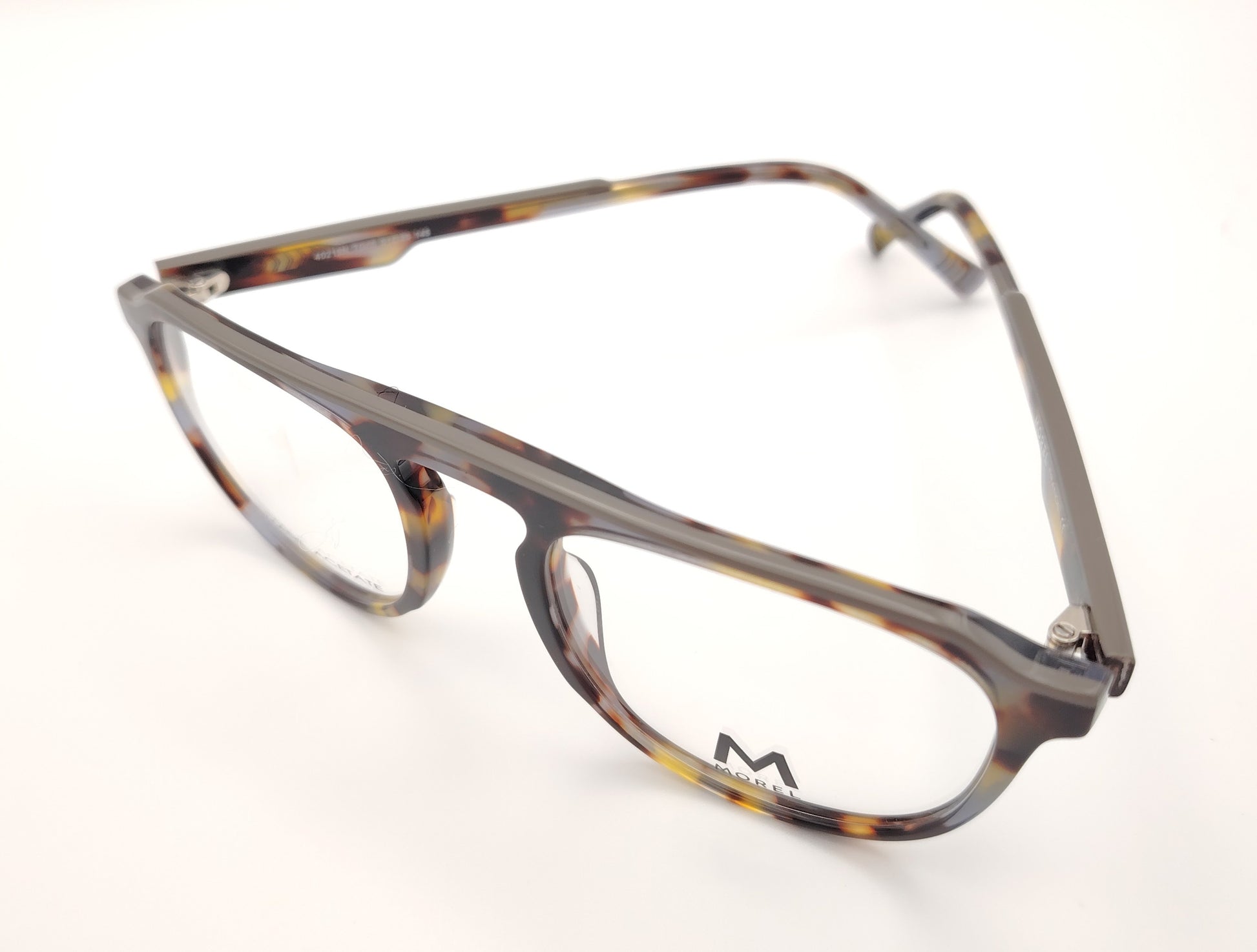 gafas de vista morel nomad con montura redondeada de acetato jaspeado en tonos marrón, gris y mostaza 