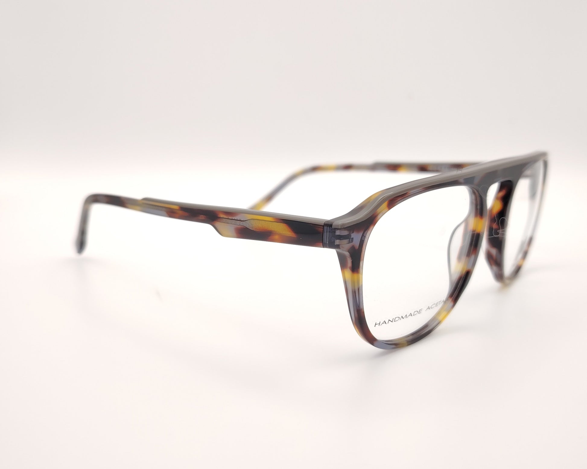 gafas de vista morel nomad con montura redondeada de acetato jaspeado en tonos marrón, gris y mostaza 