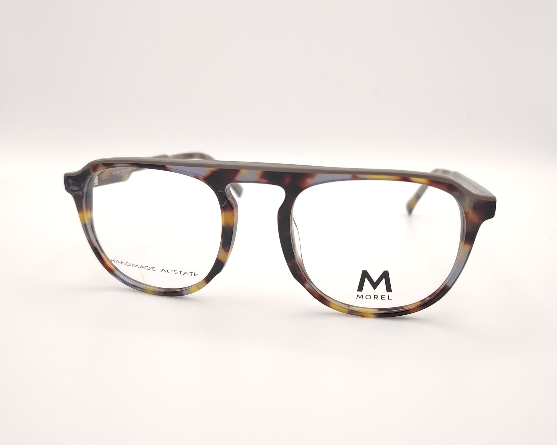 gafas de vista morel nomad con montura redondeada de acetato jaspeado en tonos marrón, gris y mostaza 