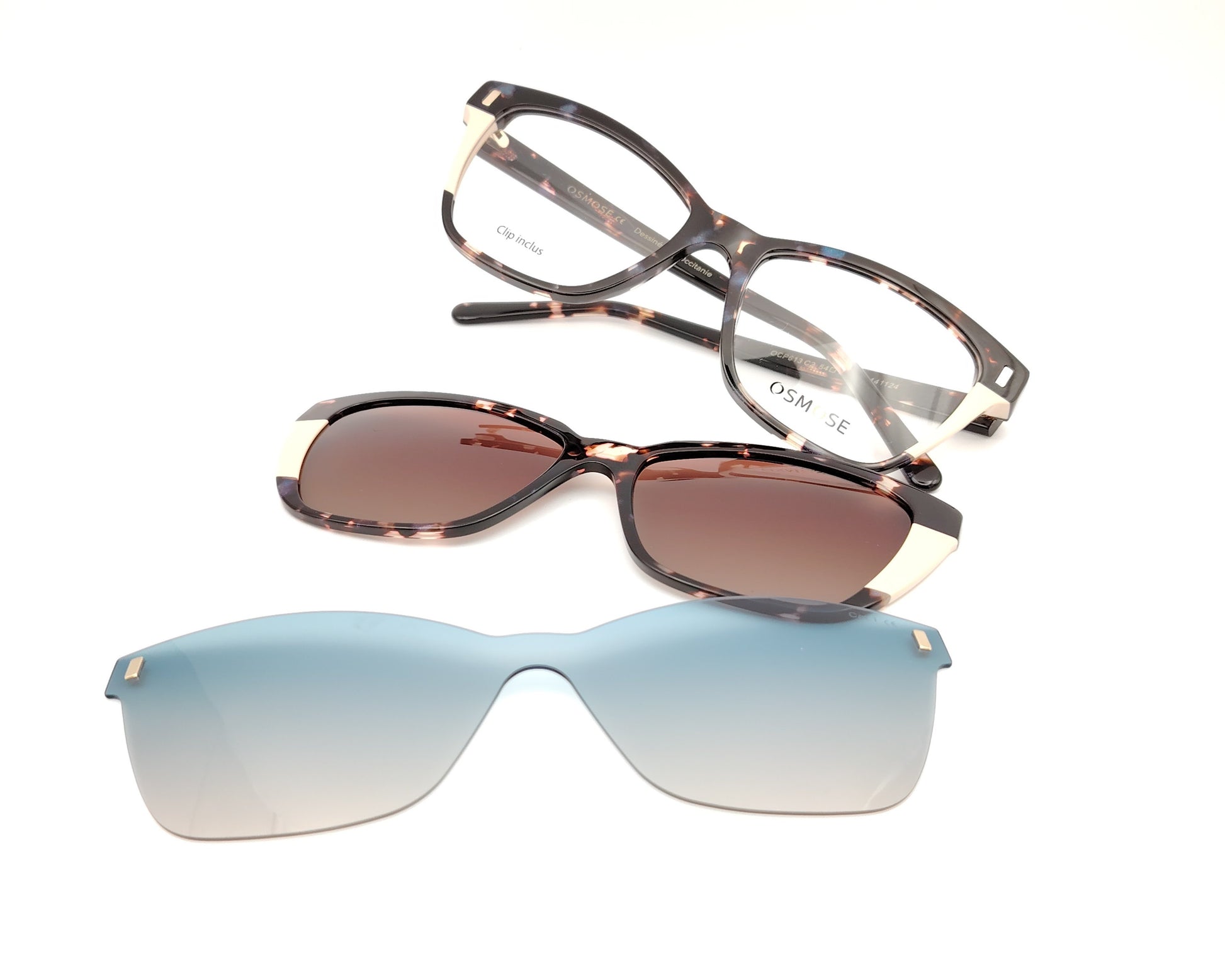 gafas de carey con detalles claros y dos clips solares, uno marrón y otro azul degradado