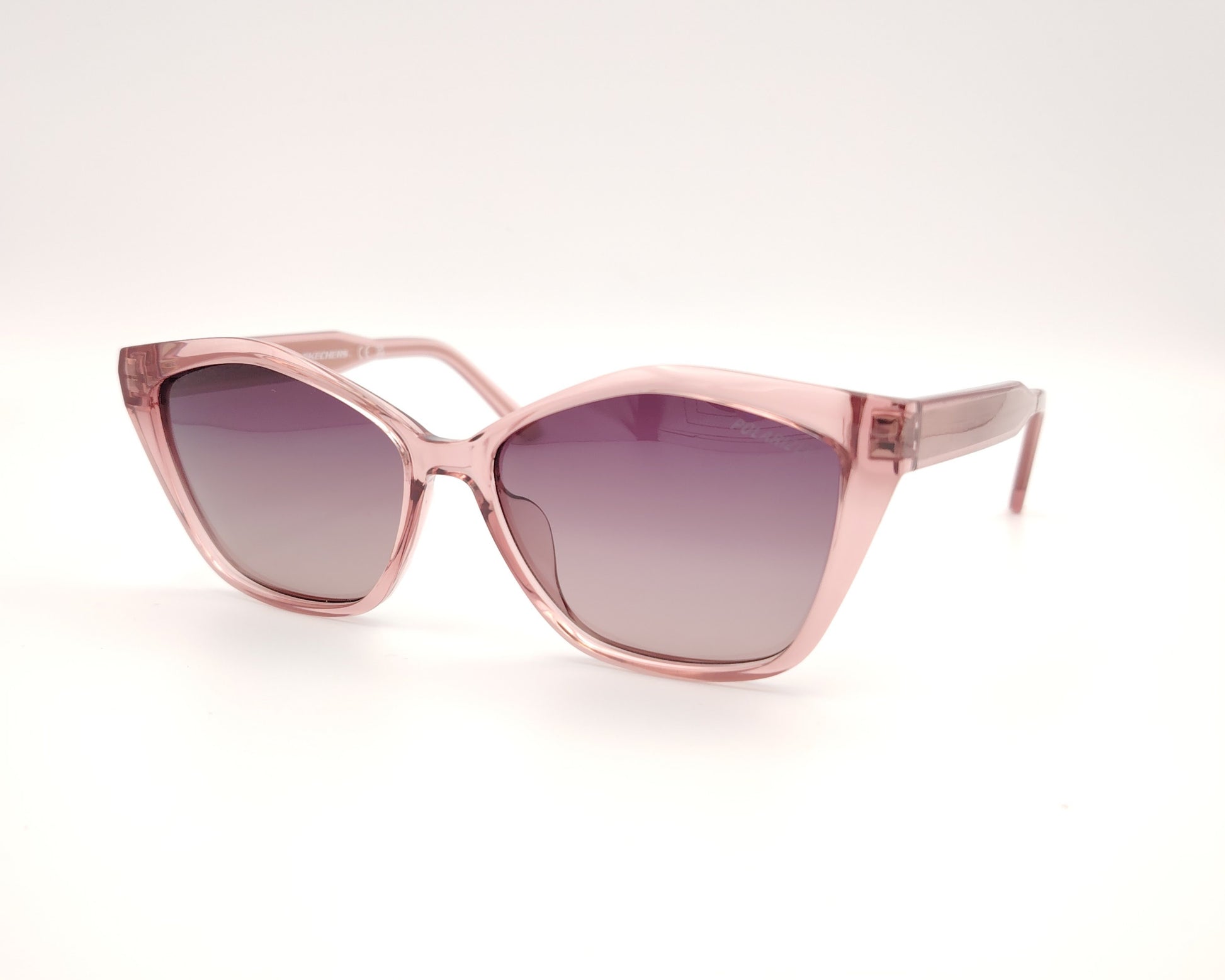 gafas de sol skechers se00035 72h con montura rosa transparente forma cat eye y lentes moradas degradadas polarizadas

