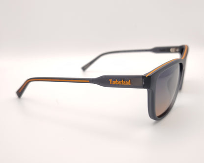 gafas de sol gris mate polarizadas con lentes marron degradado y detalle naranja en varillas