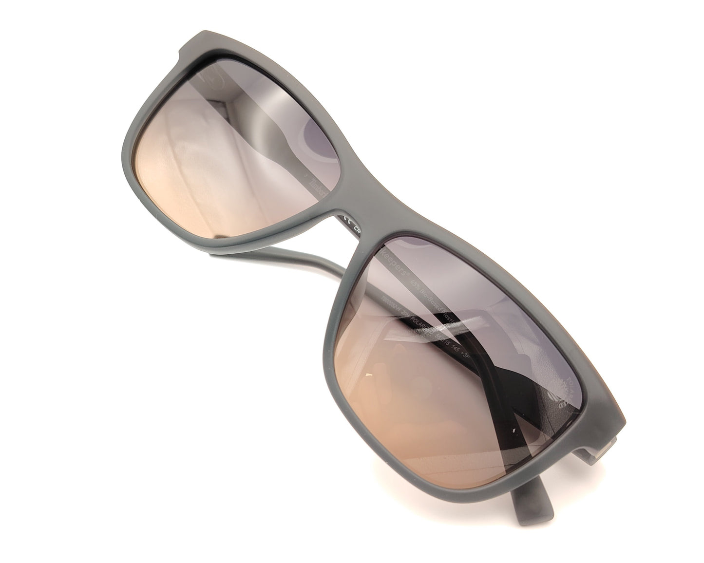 gafas de sol gris mate polarizadas con lentes marron degradado y detalle naranja en varillas