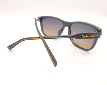 gafas de sol gris mate polarizadas con lentes marron degradado y detalle naranja en varillas