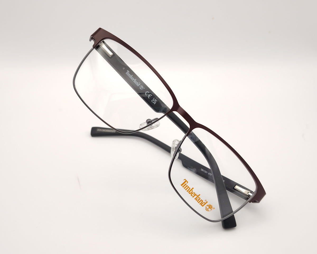 gafas de vista timberland con montura rectangular de metal en color burdeos con varillas negras de acabado mate