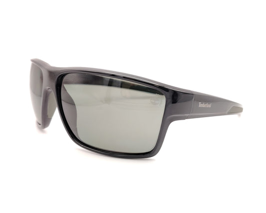 gafas de sol negras polarizadas con lentes gris y diseño deportivo envolvente