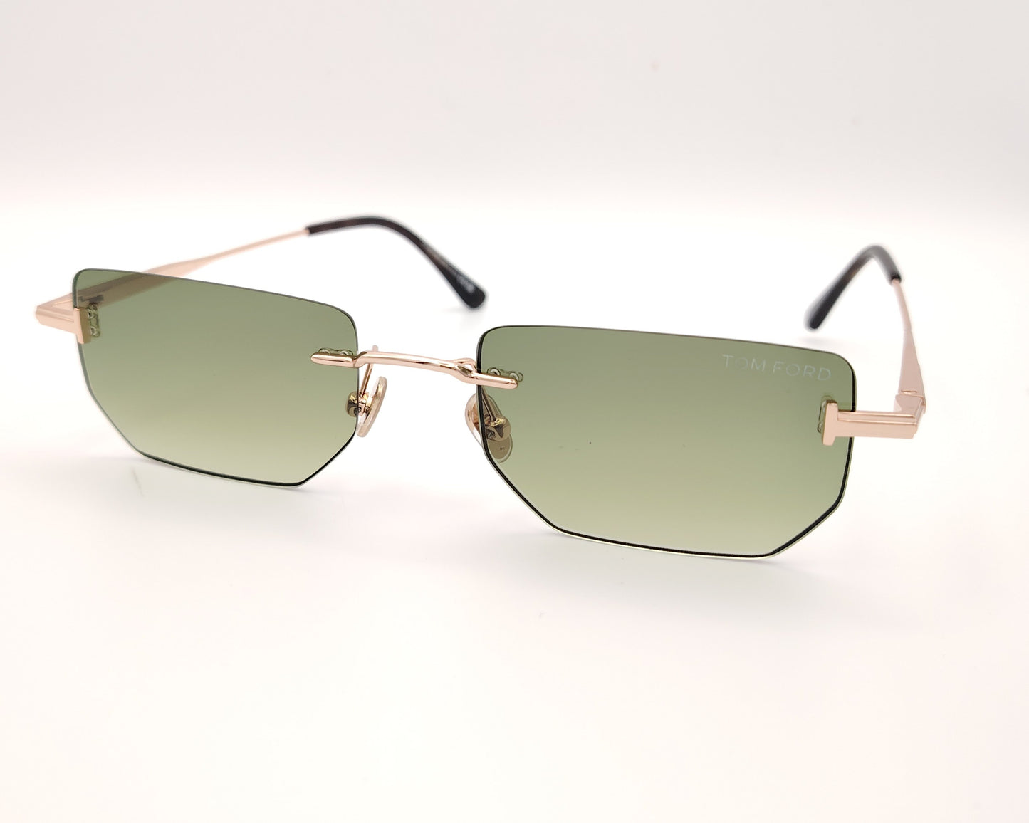 gafas de sol tom ford sin montura con lentes verdes y varillas metálicas doradas