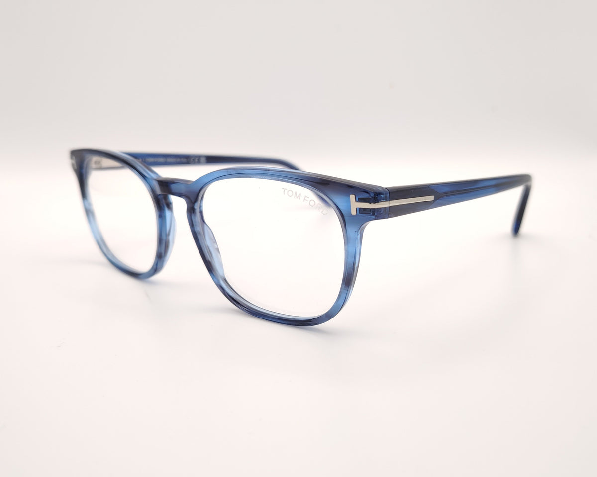gafas de vista tom ford con montura cuadrada de acetato azul jaspeado y detalle metálico de la marca en el talón