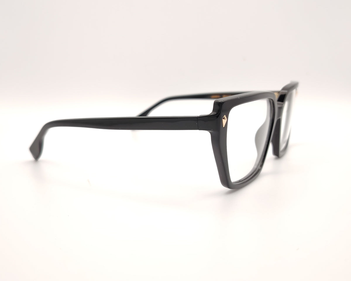 gafas de pasta negras con forma rectangular y detalle dorado en las esquinas delanteras, modelo visionario