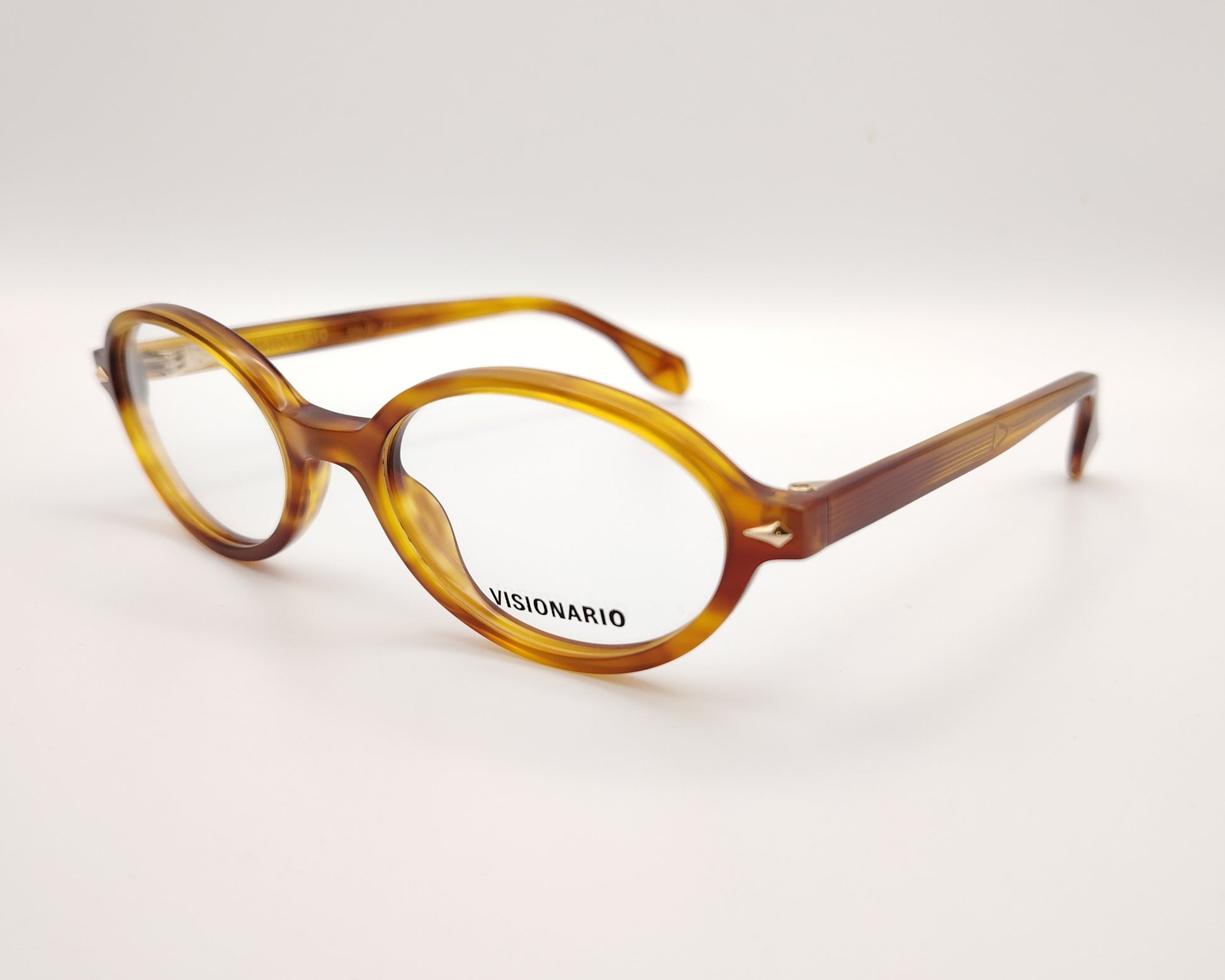gafas de vista ovaladas en acetato ámbar con detalles metálicos dorados de la marca visionario